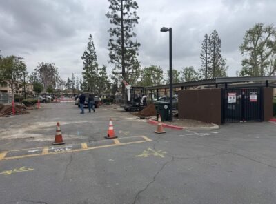 Construction site with equipment and workers present.